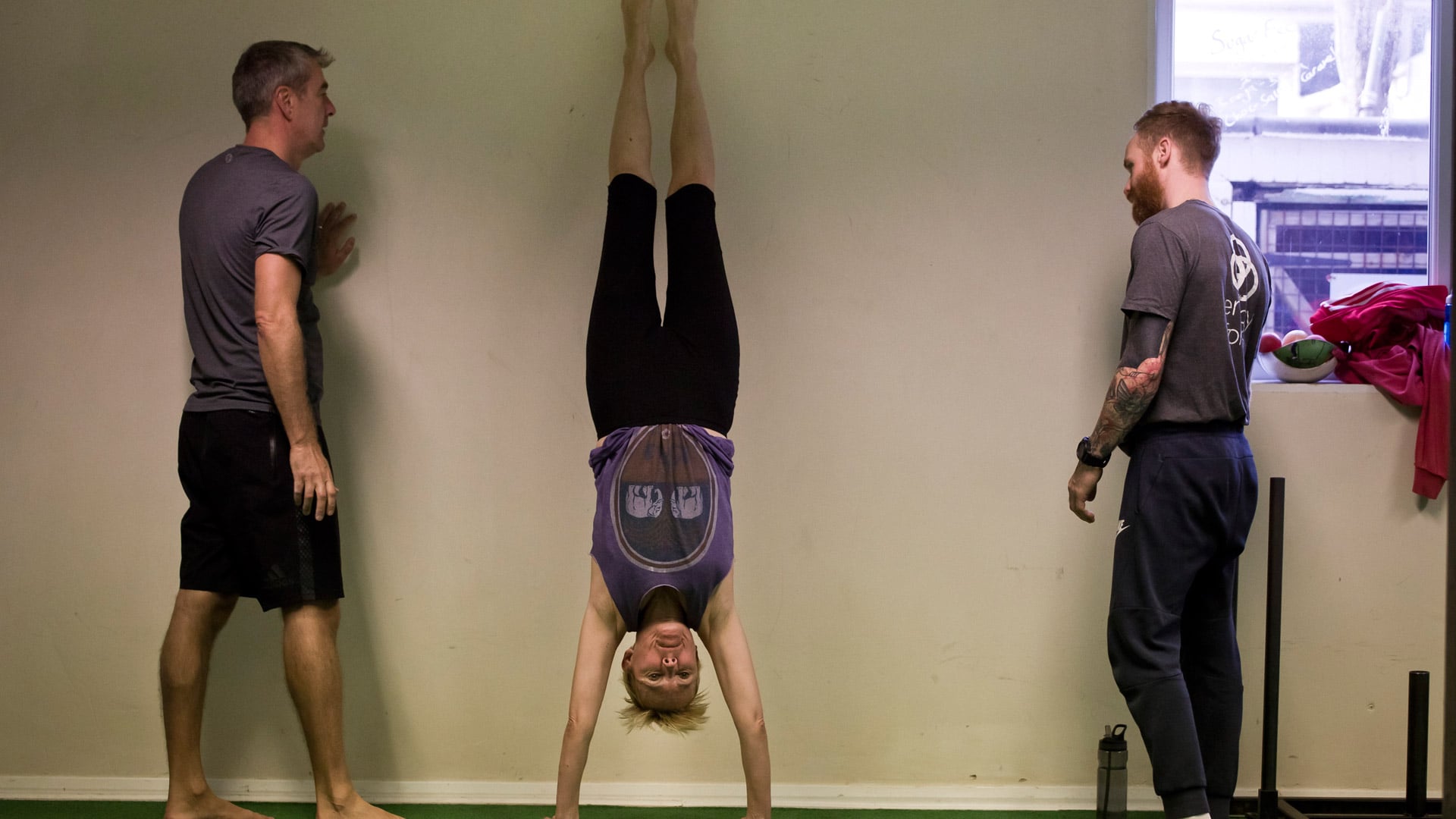 Lady learning handstands