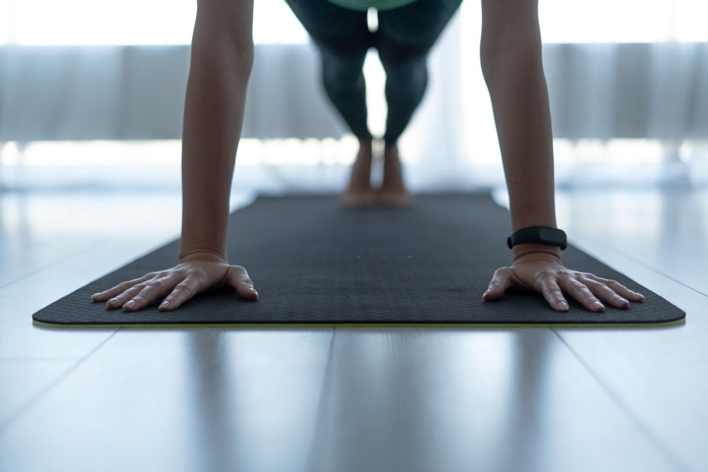 Student holding a plank in Pilates class