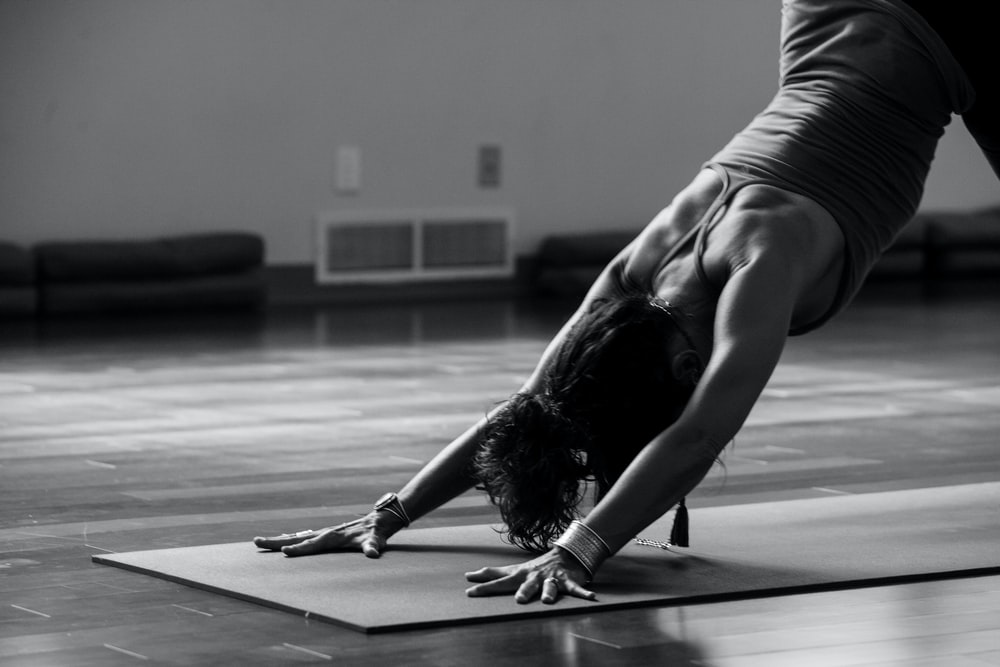 Emma in Downward facing dog pose shot in our Brighton yoga studio