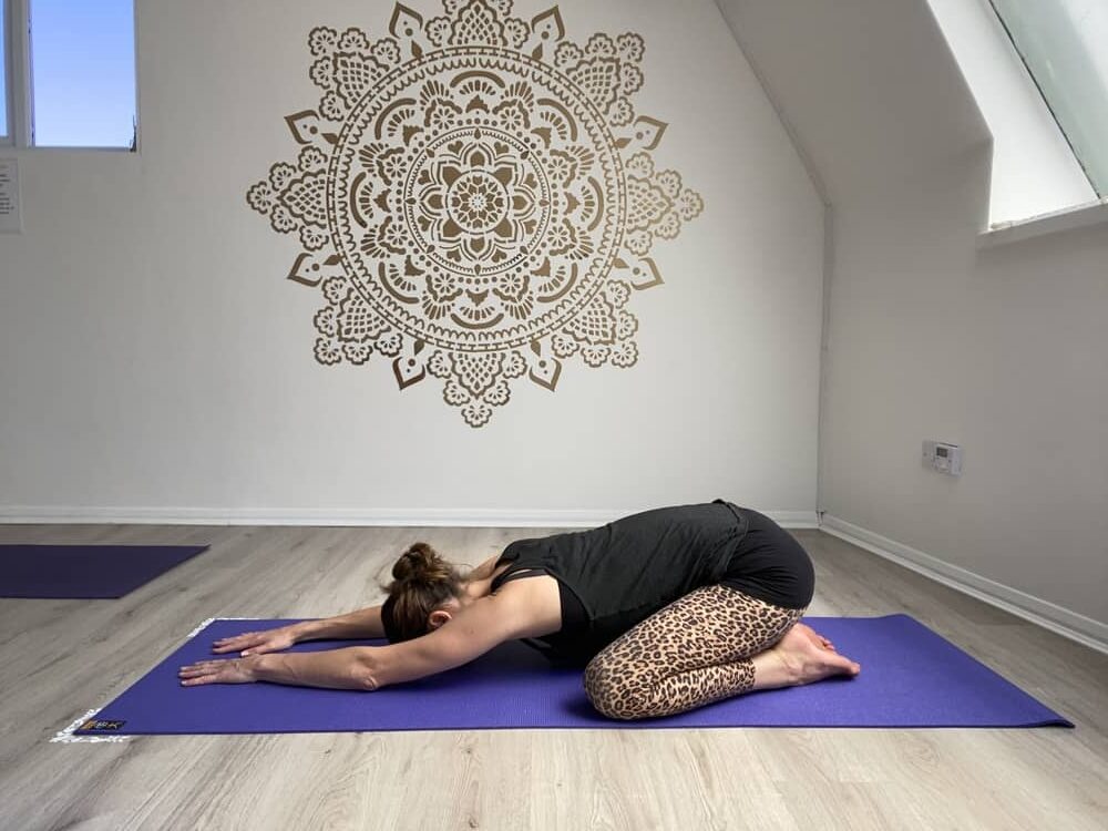 Emma in Childs Pose shot in our Brighton yoga studio